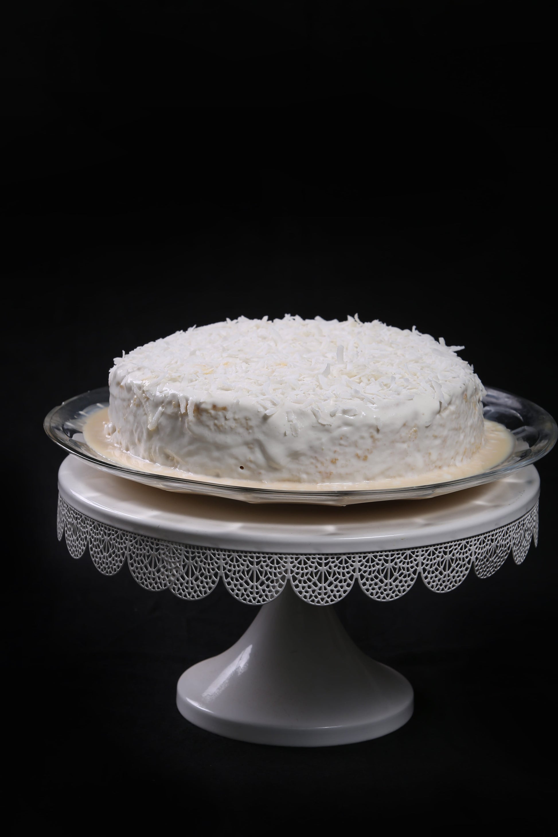 Coconut Infused Tres Leches Cake or Three Milk Cake with Coconut Cream Topping and Coconut Flakes