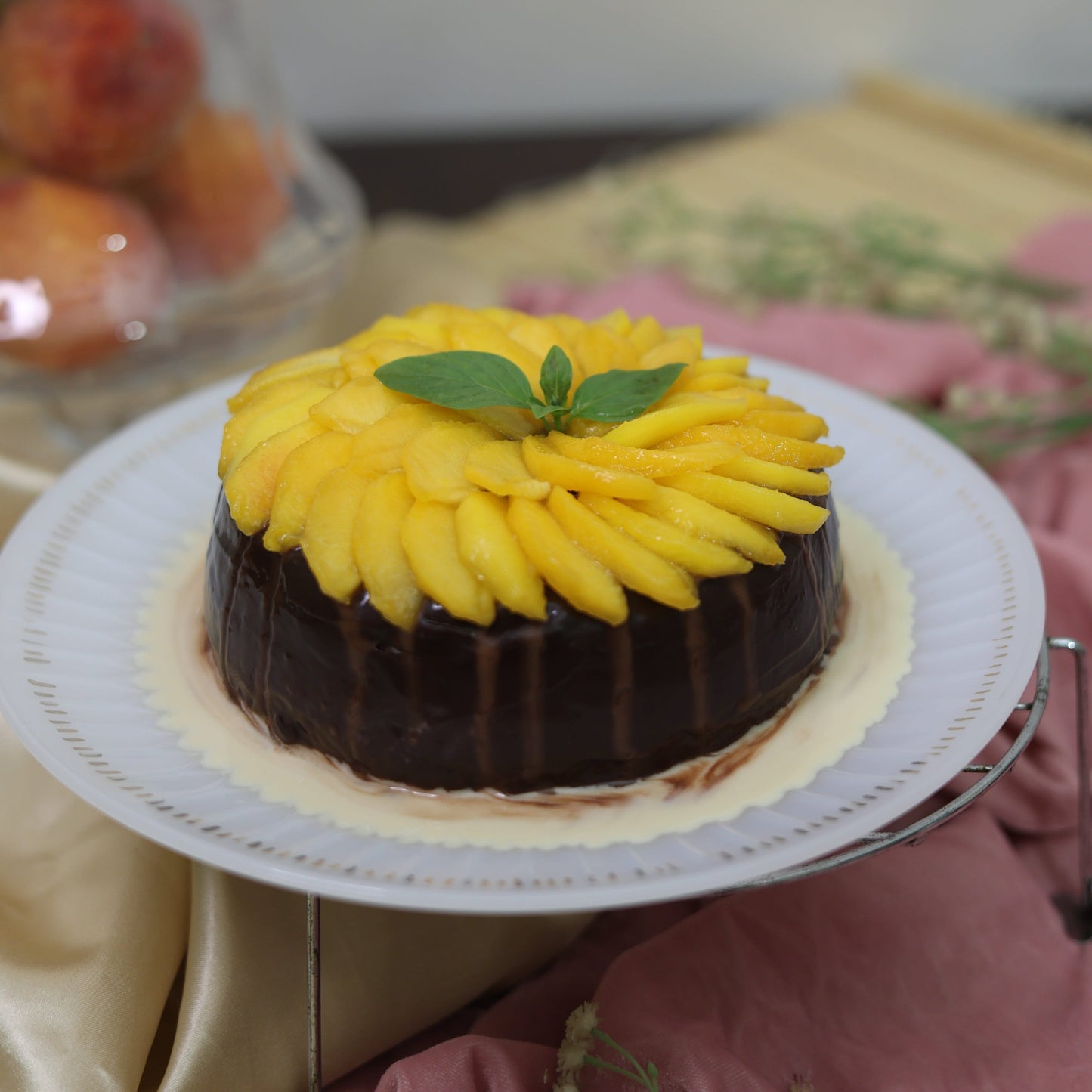 Peach and Chocolate Tres Leches Cake: A soft sponge soaked in Tres Leches, layered with sweet peaches and rich chocolate, topped with fresh cream.
